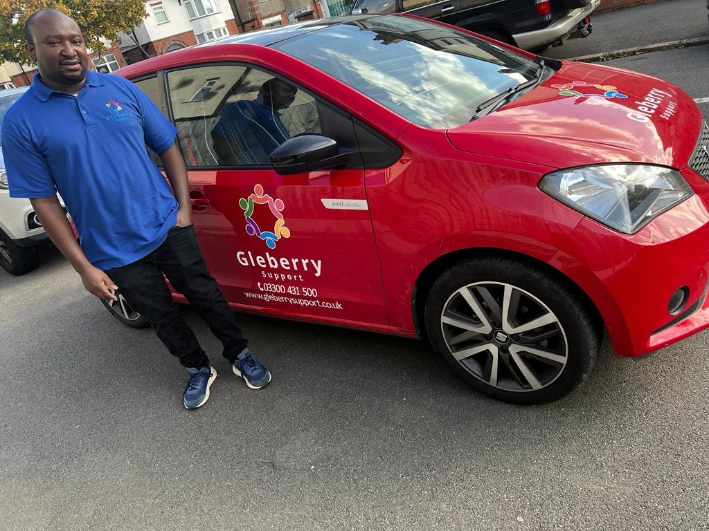 Gleberry Support staff member with branded red car